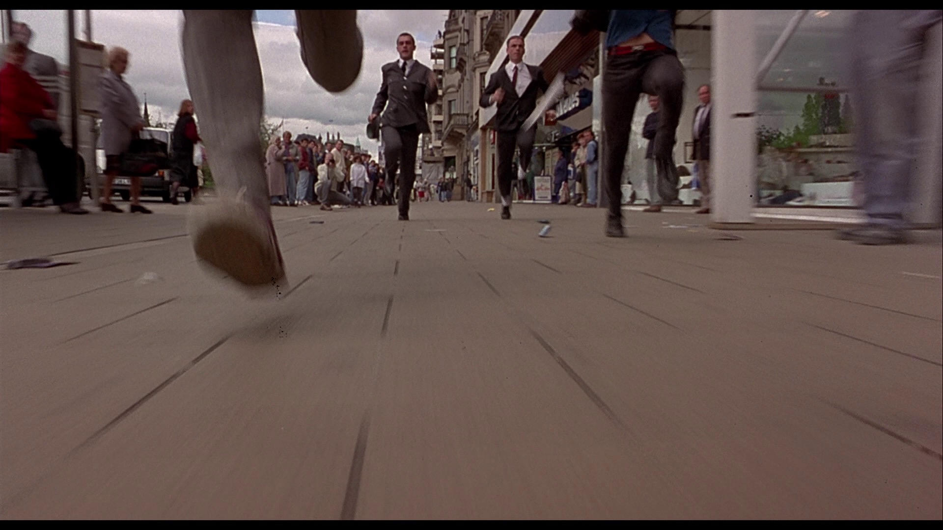 Screenshot from the original blu-ray of Trainspotting depicting the opening scene chase