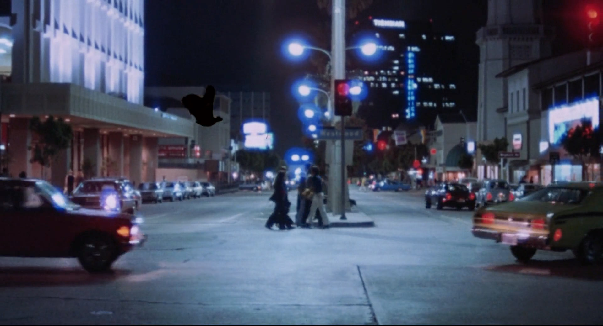 A superimposed animation of a bat silhoutte flying throuygh traffic in "Scream Blacula Scream"